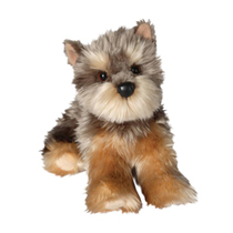 A fluffy yorkie plush sitting down.